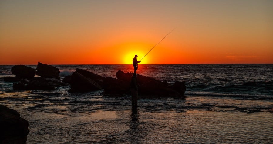 man fishing in the sunset