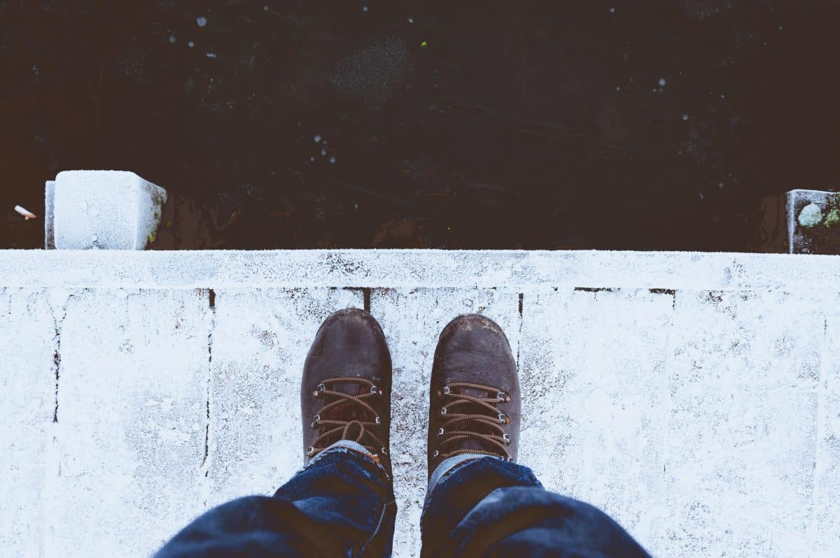Man standing on dock with ice boots
