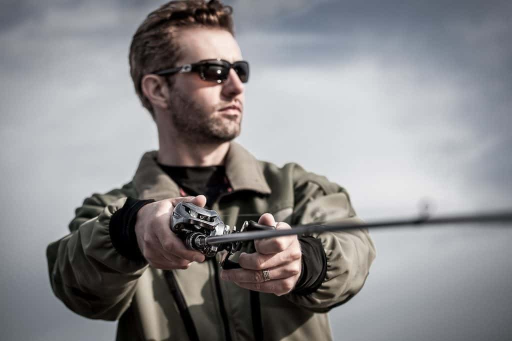 fisherman with sunglasses casting