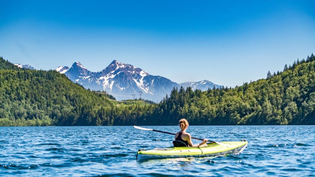 woman in beginner kayak looking ta mountains